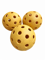 Three yellow HighBounce pickleballs on a white background